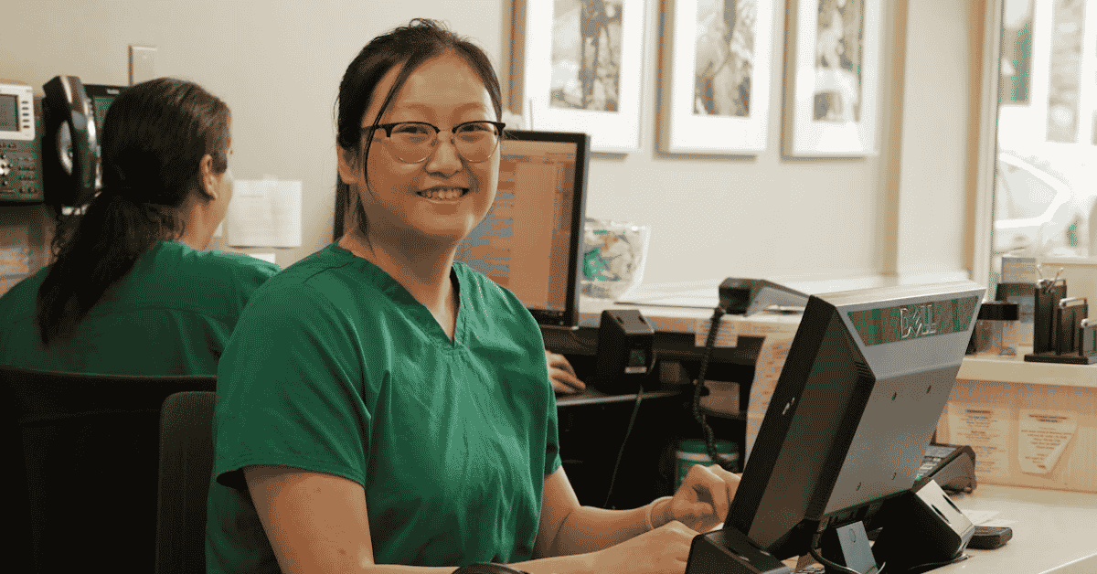 Cindy sitting at reception desk
